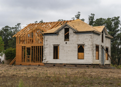 house framing under construction in cloudy weather
