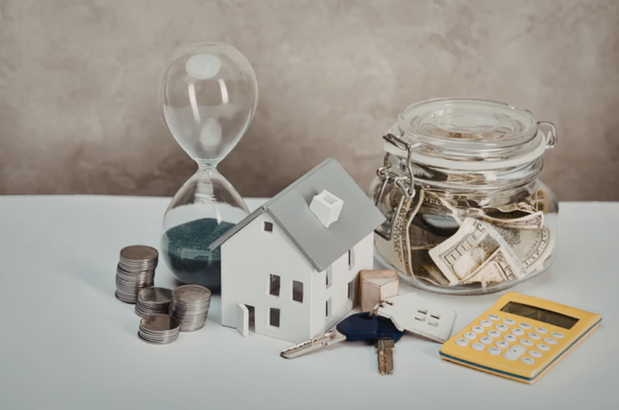House model with savings and calculator for budgeting.