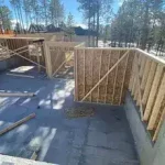 Wood framing structure under construction on concrete slab