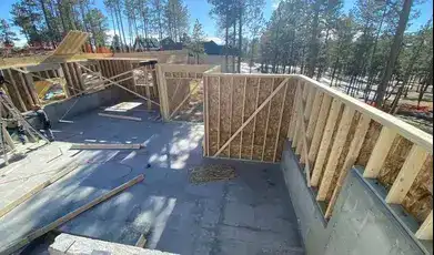 Wood framing structure under construction on concrete slab