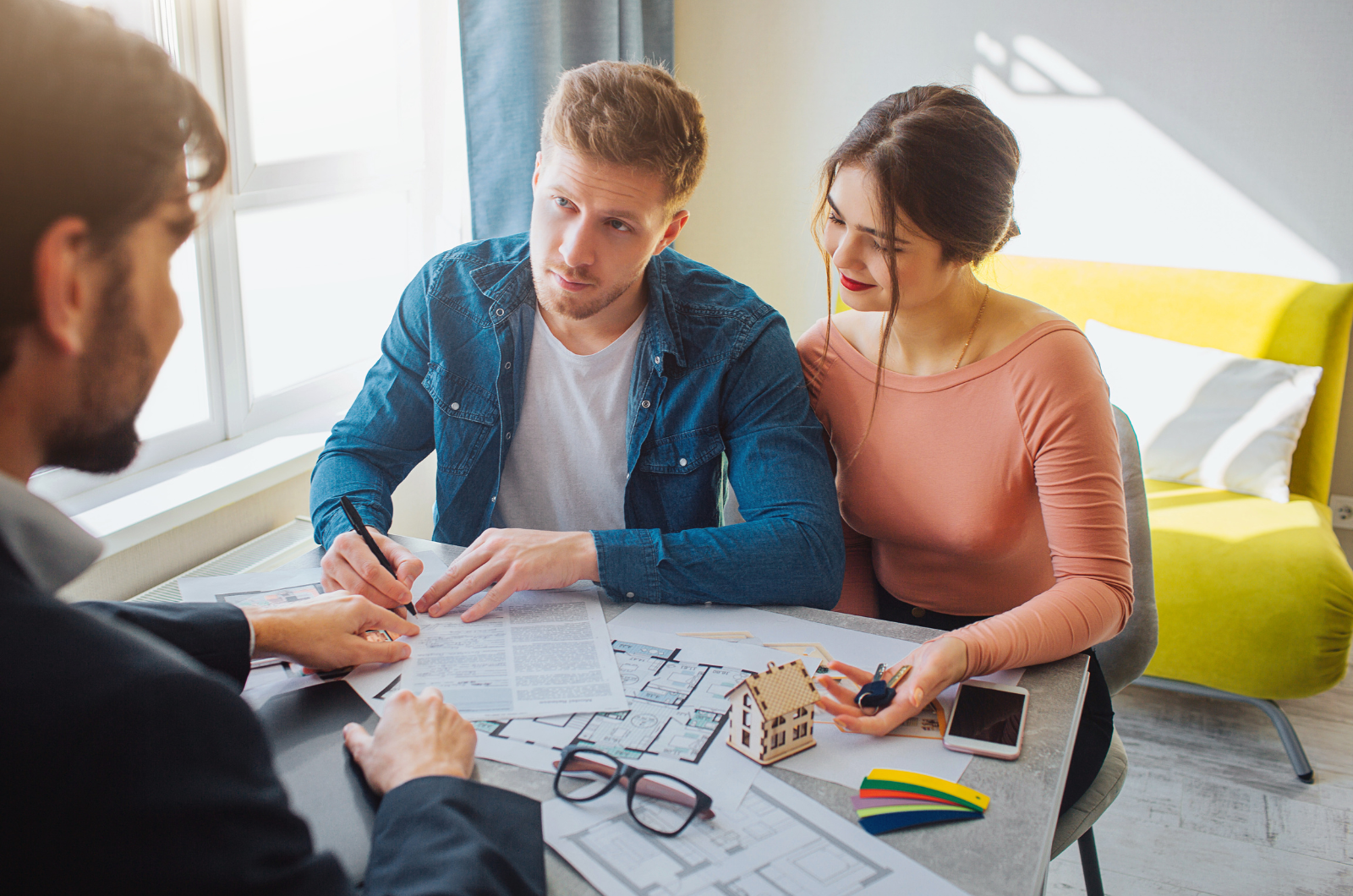 Future homeowners meeting a custom builder to plan a home